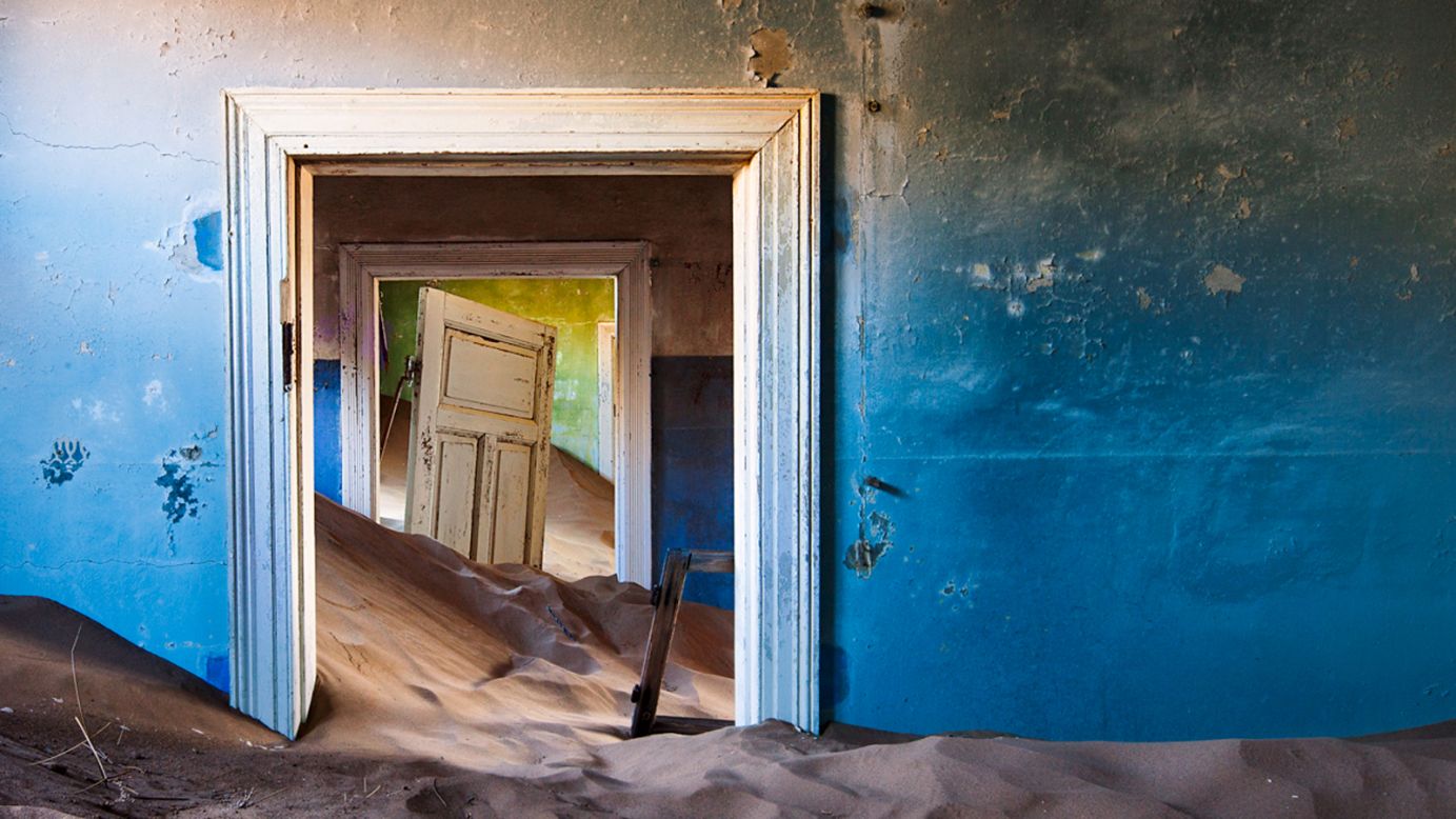 The abandoned Namibian diamond mining town of Kolmanskop is a surreal and eerie gift to photographers.<br /><br />Once home to 1,000 people, the place was abandoned in the early 1900s when better rock-hunting grounds were found further south.<br /><br />Shifting desert sands soon reclaimed the town's 40 or so buildings, drifting in through windows and doorways.<br />Despite standing empty for more a century, the town is remarkably well preserved. Colorful house interiors remain bright because of the dry climate.