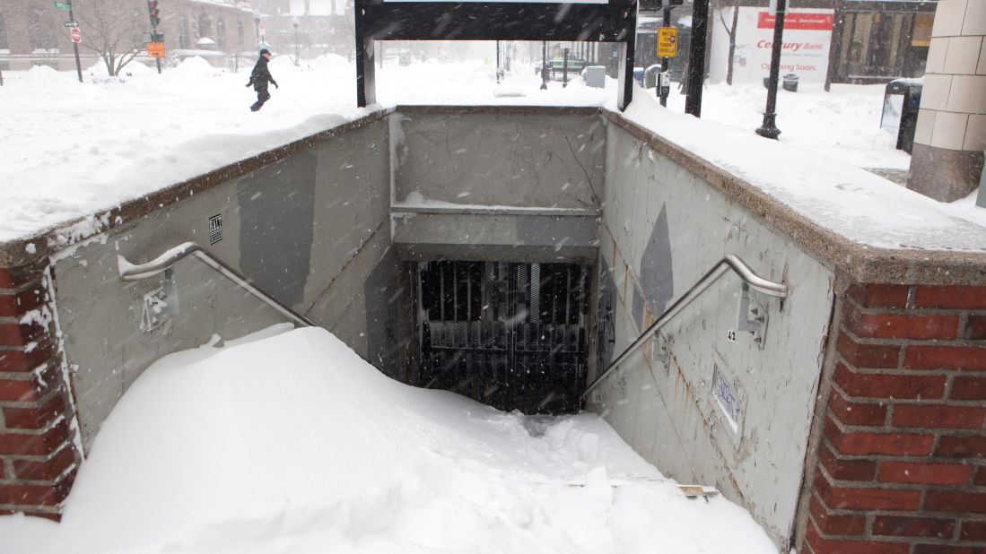 Snow piles up at the entrance of a closed T station in Boston on January 27. The city's public transit system was set to reopen the next day.