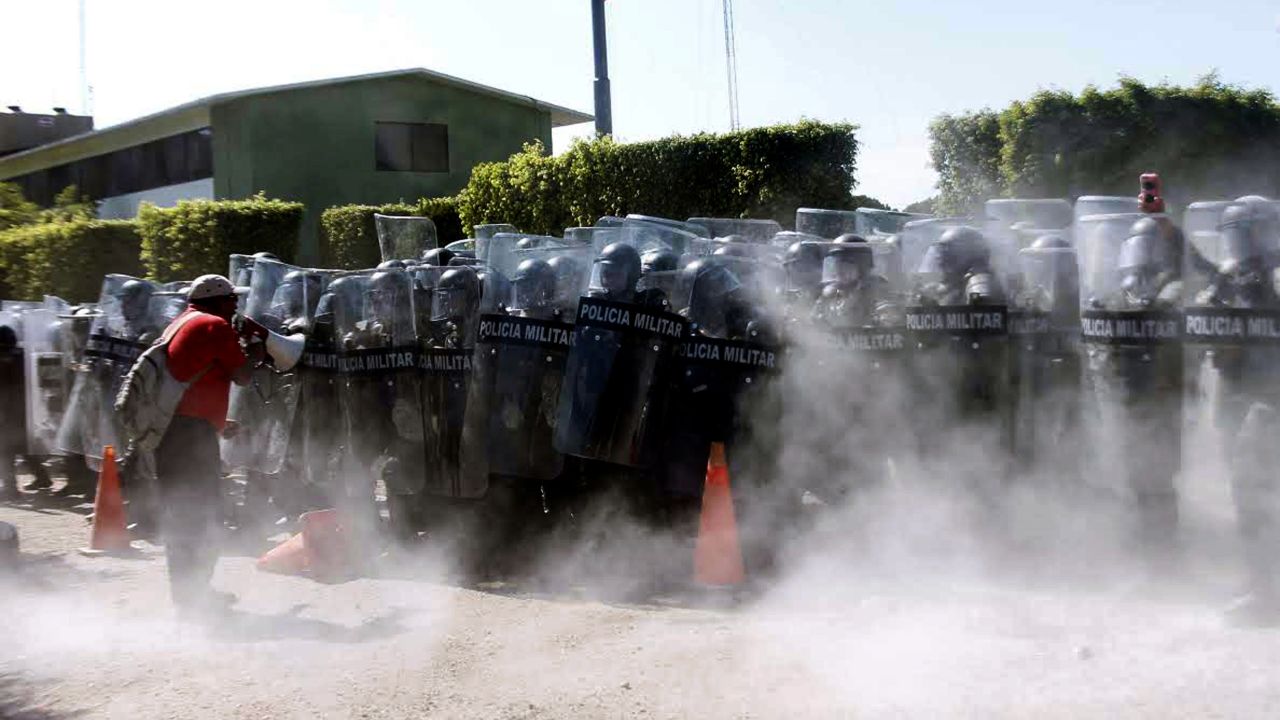 Military police spray tear gas during a protest in Iguala, Mexico, on Monday, January 12.