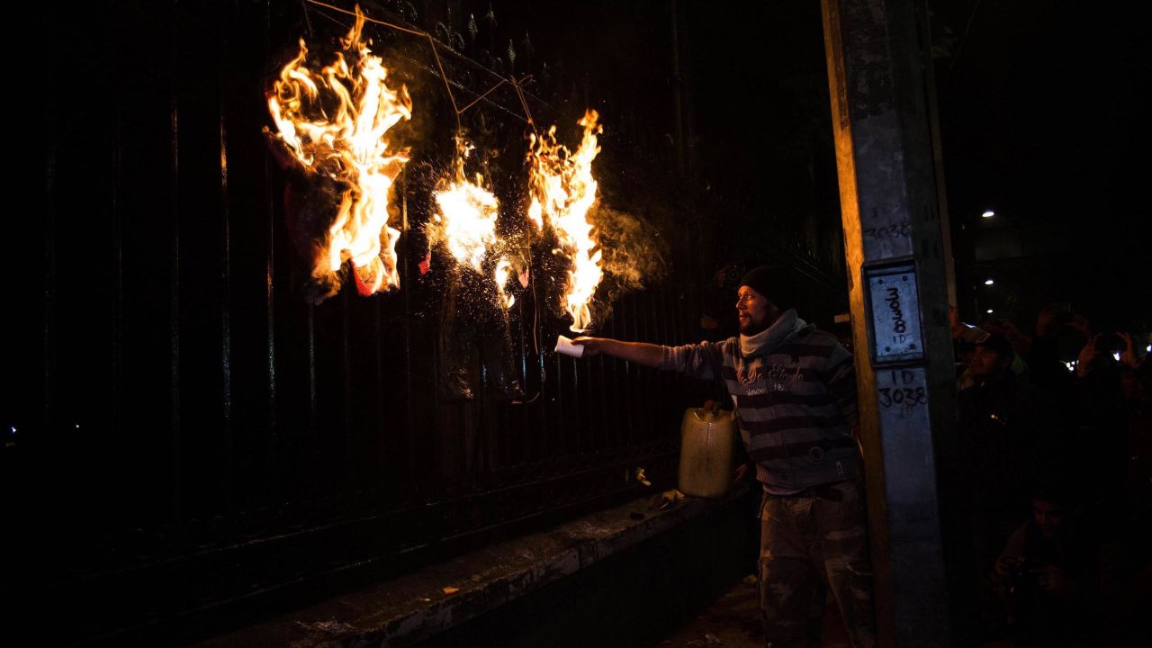 A man burns an effigy of Mexican President Enrique Pena Nieto during a protest in Mexico City on Wednesday, December 31.