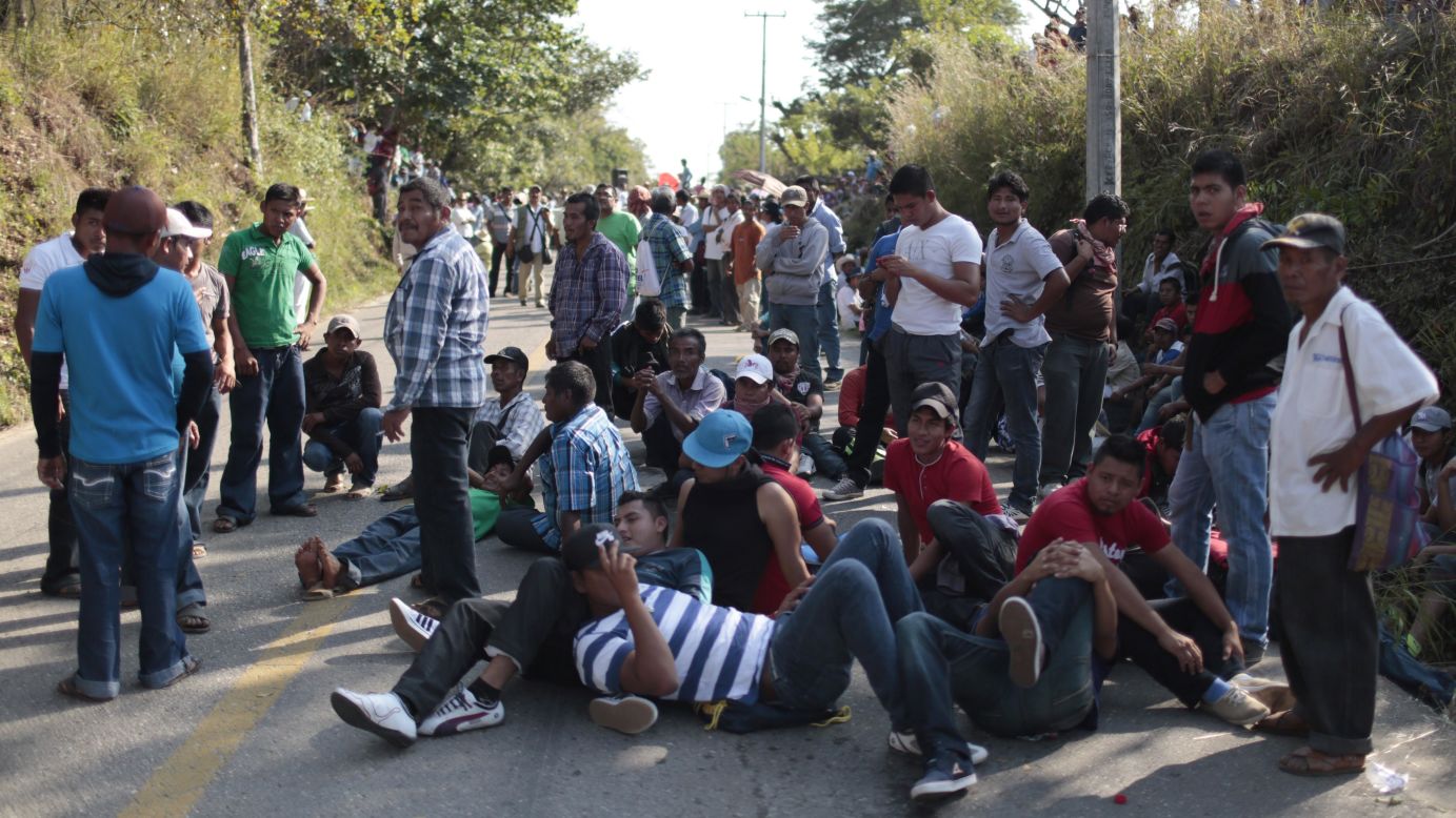 Hundreds of residents of Ayutla, Mexico, and parents of the missing students participate in a protest on Wednesday, December 17.