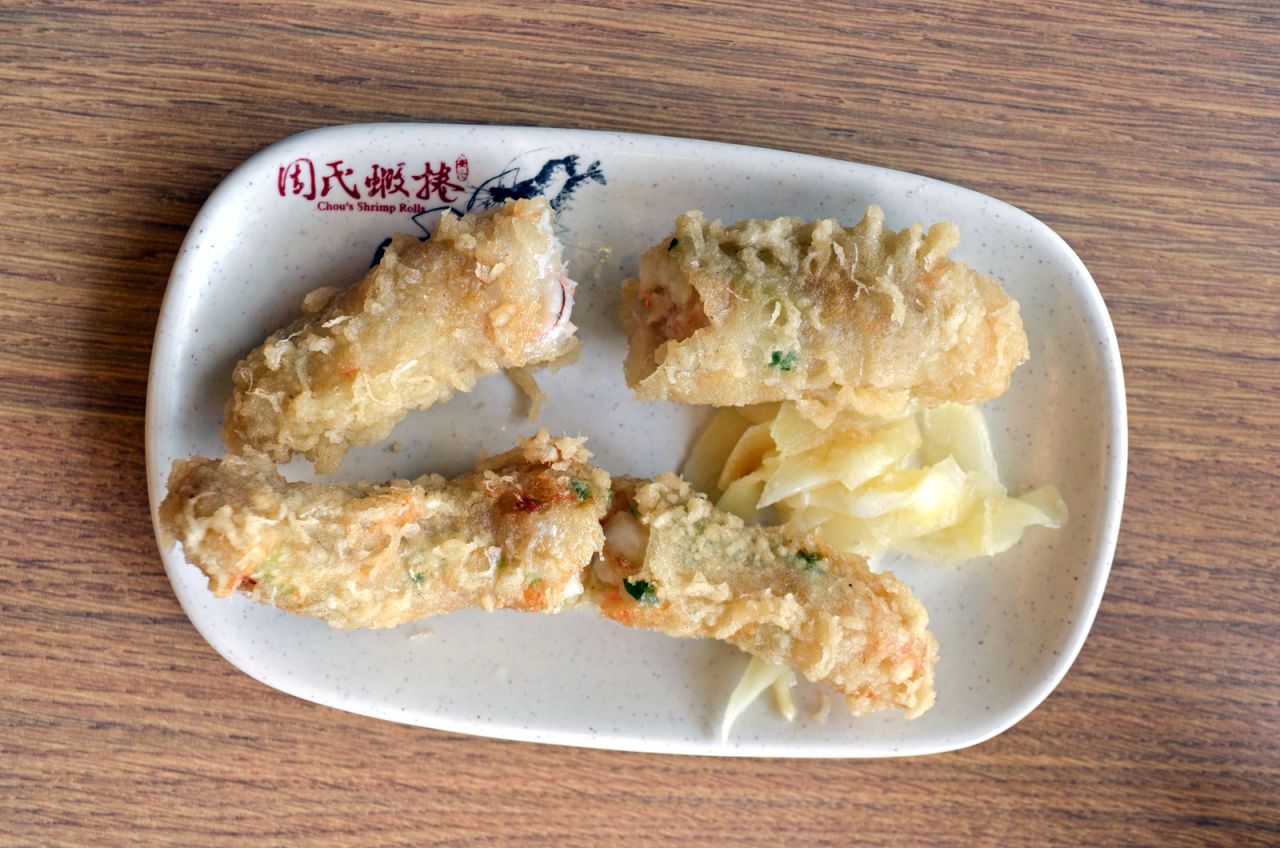 Shrimp rolls are a Taiwanese rendition of Japanese tempura, except the shrimps are wrapped in caul fat and stuffed with scallions before they're deep fried.