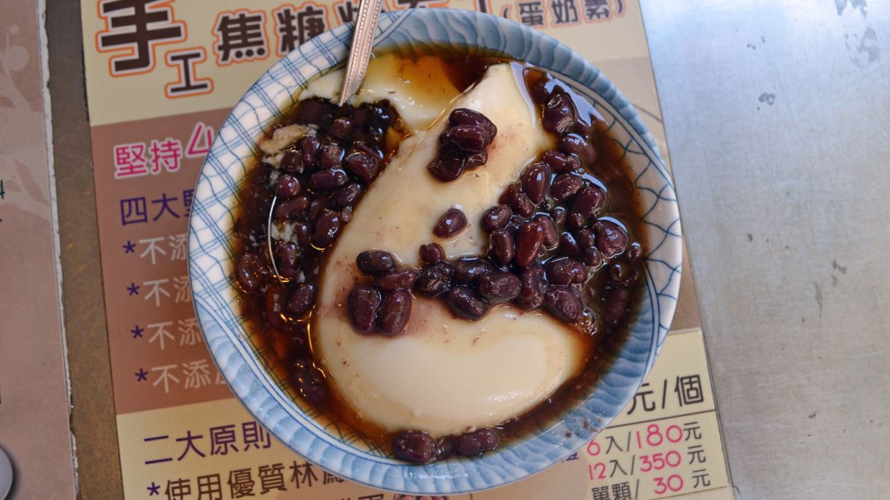 Tofu pudding is made with soy beans and comes bathed in brown sugar and topped with either red bean, green bean or taro.
