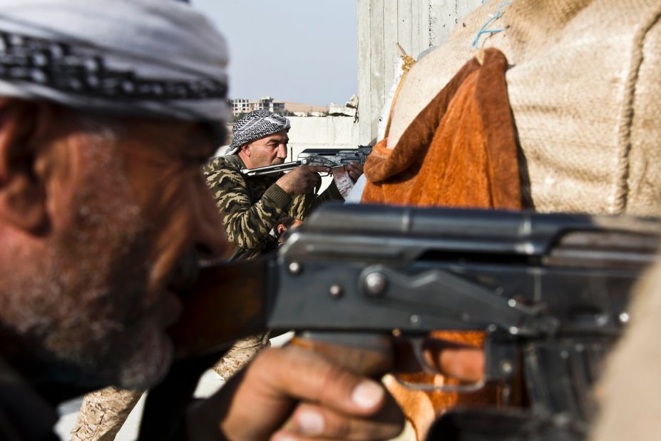 Fighters from the Free Syrian Army and the Kurdish People's Protection Units join forces to fight ISIS in Kobani on Wednesday, November 19.