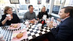 Former GOP presidential candidate Mitt Romney, second from left, former Mississippi Republican Lt. Gov. Amy Tuck, left, Megan Mullen, wife of Mississippi State football coach Dan Mullen and Dan Mullen, right, talk as they have dinner at Little Dooey, a barbecue restaurant in Starkville, Miss., Wednesday, Jan. 28, 2015. Romney hasn't officially declared himself a presidential candidate again, but the 2012 Republican nominee looked and sounded like one during the stop in Mississippi. (AP Photo/Rogelio V. Solis)