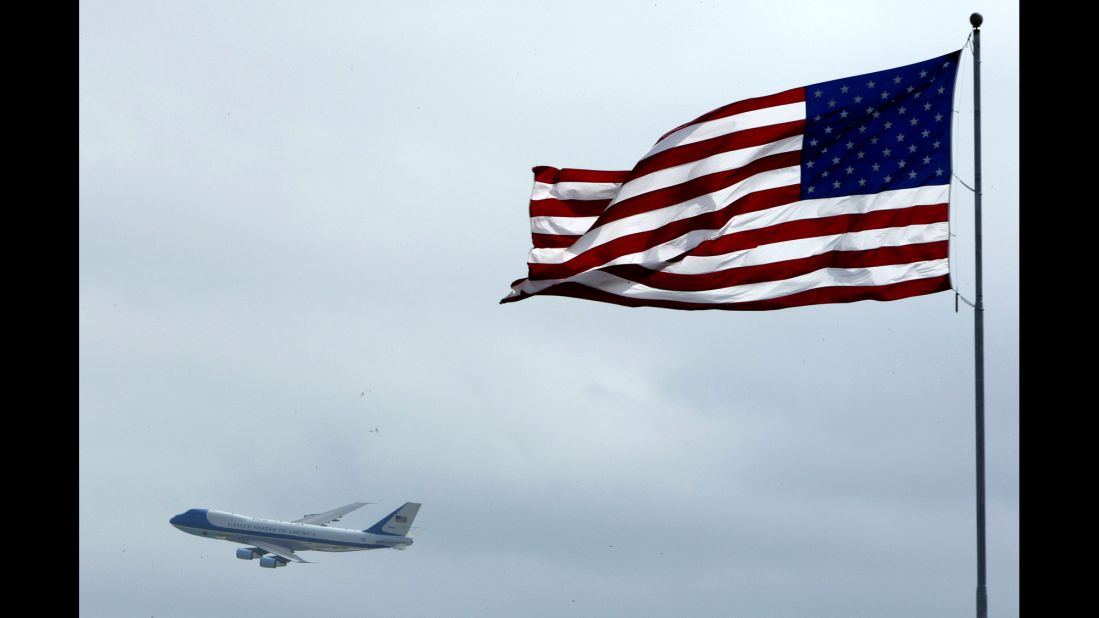 Air Force One flies past an American flag on its way into Daytona Beach, Florida, in 2004. The U.S. Air Force announced Wednesday, January 28, that a customized military version of Boeing's 747-8 will serve as Air Force One for future Presidents. Click through to see the different airplanes that have served as the President's transportation over the years.