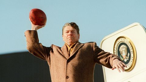 President Ronald Reagan throws a football toward the press before boarding Air Force One in 1988.