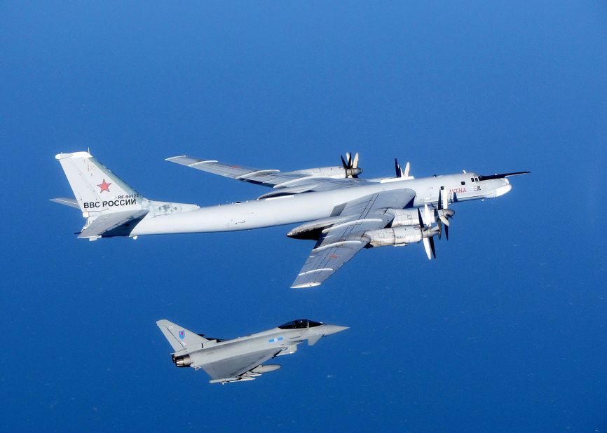 A Russian Tu-95 Bear bomber is escorted by a British Royal Air Force Typhoon fighter during an intercept in September 2014. Click through the gallery to see other intercepts in late 2014.