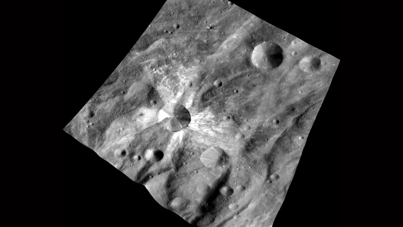 This image taken on October 20, 2011 from an altitude of about 420 miles (680 kilometers) shows Vesta's crater "Canuleia." About 6 miles (10 kilometers) in diameter, it is notable for the rays of bright material that seem to emanate from it. To the northeast, scientists also identified a presently unnamed crater of about the same size.