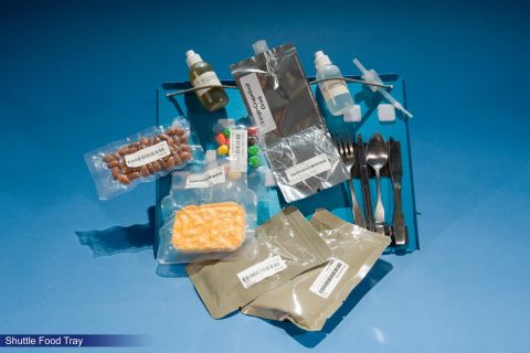 Rehydratables from the Space Shuttle missions (1981-1989), and the first appearance of M&Ms on the space food menu. Referred to simply as "candy-coated chocolates" by NASA, they are now a regular space snack. Note also the magnets securing the cutlery to the tray. 