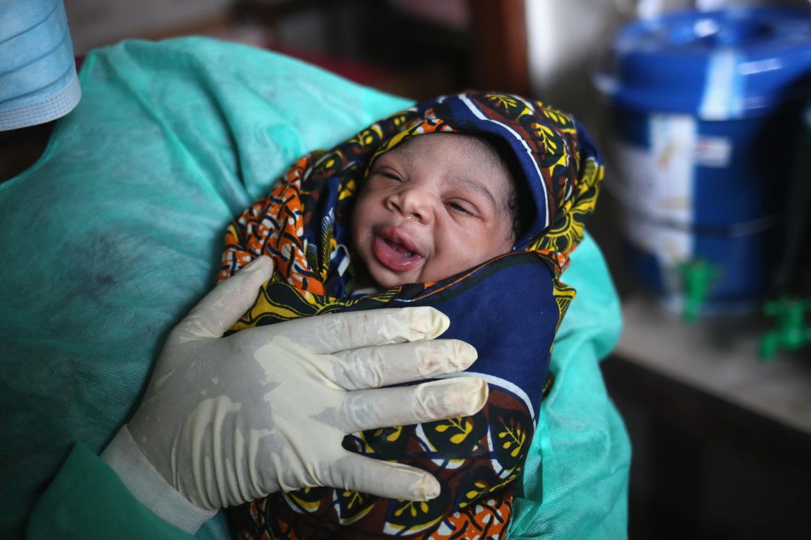 JANUARY 29, 2015 - MONROVIA, LIBERIA: Midwife Maima Johnson holds a healthy baby girl born at the Star of the Sea Health Center in West Point township on the day the World Health Organization announced that medical staff <a href="http://edition.cnn.com/2015/01/29/africa/ebola-virus/index.html">appear to be winning the battle against Ebola</a>. New <a href="http://edition.cnn.com/2015/01/29/africa/winning-the-ebola-battle/index.html">cases in Liberia are now down to single figures</a>, according to the WHO.
