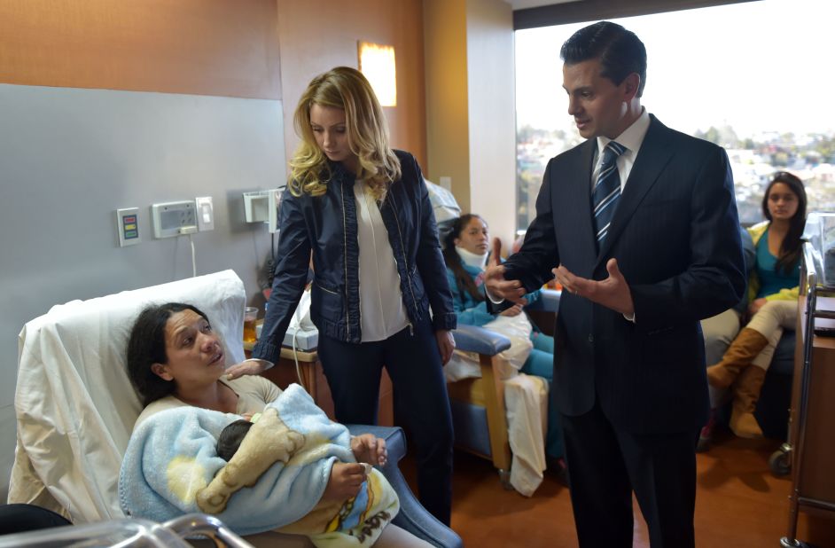 Mexican President Enrique Peña Nieto and his wife, Angelica Rivera, talk with an injured woman at ABC Hospital in Mexico City.