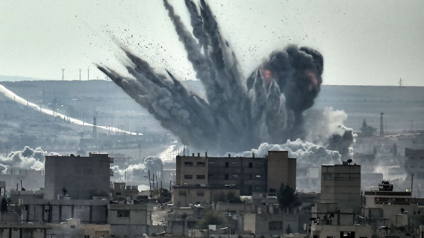A shell explodes on November 13, 2014, in the Syrian city of Kobani, as seen from the Turkish border.