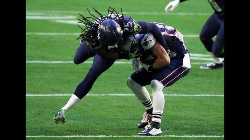 Seattle cornerback Richard Sherman tries to tackle Amendola.