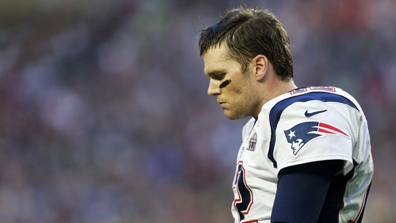 Brady walks off the field after throwing a first-quarter interception.