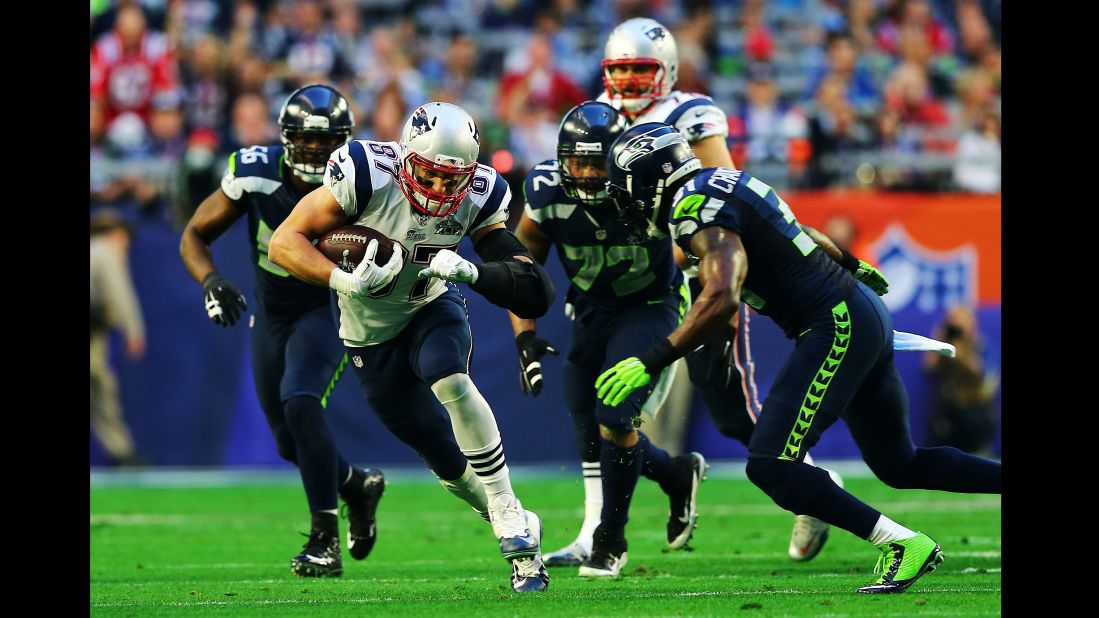 Gronkowski tries to evade Seattle defenders after a first-quarter catch.