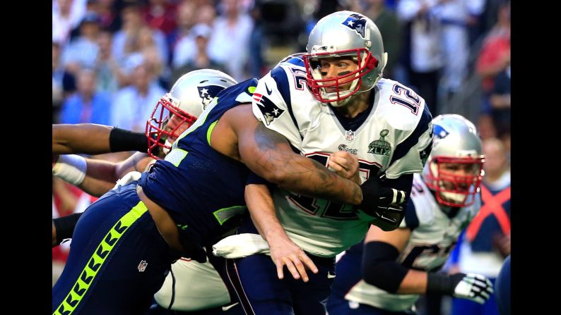 Seattle's Michael Bennett hits Brady in the first quarter.