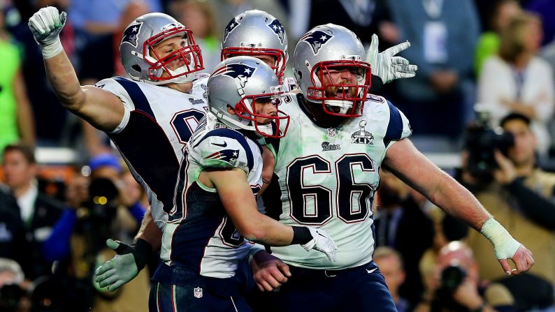 New England tight end Rob Gronkowski, left, celebrates with teammates after catching a 22-yard touchdown pass in the second quarter. The touchdown and the extra point gave the Patriots a 14-7 lead.