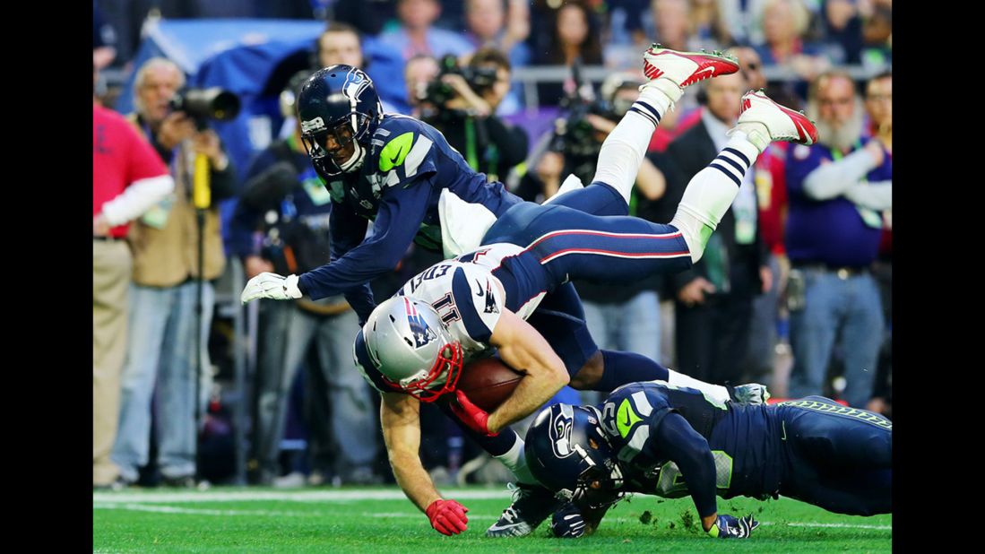 Edelman is tackled by two Seahawks during the first half.