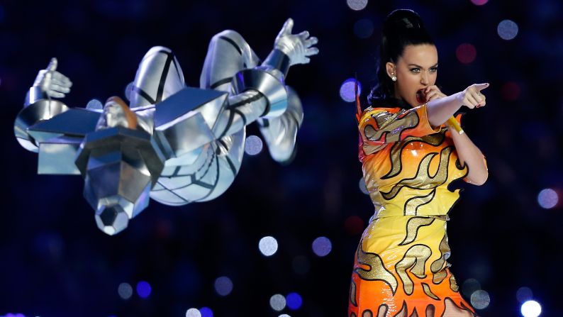 A dancer flips near Perry during the show.