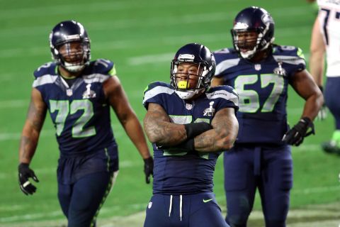 Seattle's Bruce Irvin, front, reacts after a sack on Brady.