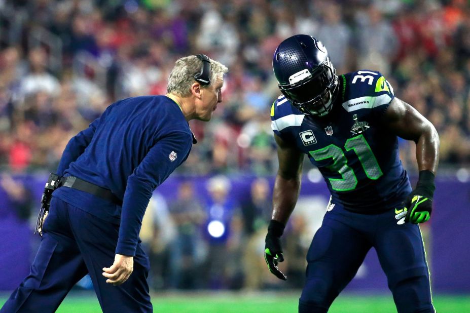 Seattle head coach Pete Carroll talks to Kam Chancellor in the second half.