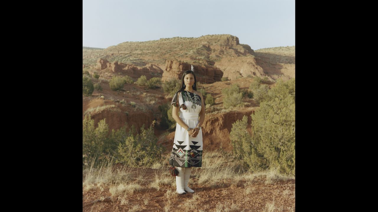 Juanita Toledo, 28, works for the community wellness program on her reservation in New Mexico. Here, she wears traditional dress and moccasins made by her family.