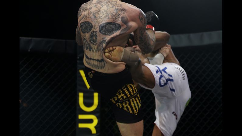Philip Mulpeter, left, is kicked by Vitor Nobrega during their MMA bout Monday, January 26, in Estoril, Portugal. Nobrega won by decision to retain his International Pro Combat welterweight title.