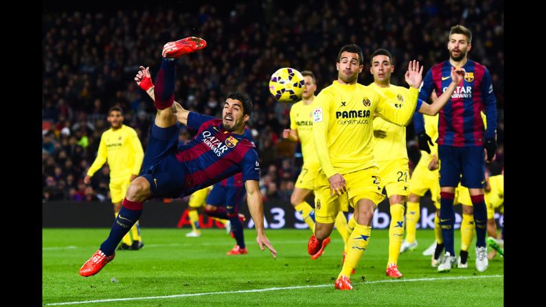 Barcelona forward Luis Suarez performs an overhead kick during a Spanish league match against Villarreal on Sunday, February 1. Barcelona won 3-2 for its eighth straight victory.