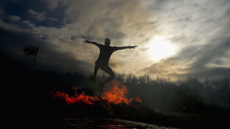 A competitor jumps over fire during the annual Tough Guy Challenge race held Sunday, February 1, in Telford, England.