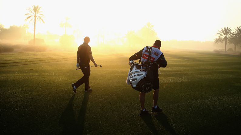 Stephen Gallacher and his caddie, Damian Moore, walk up a fairway during a pro-am event held Wednesday, January 28, in Dubai, United Arab Emirates.