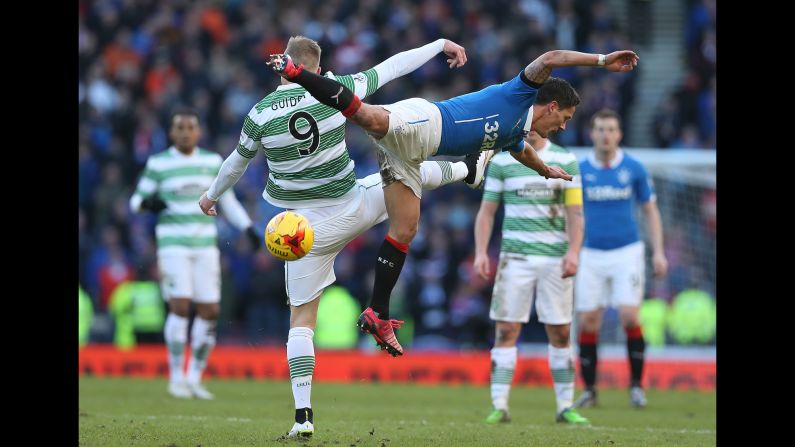 Celtic forward John Guidetti clashes with Ian Black of Rangers during a League Cup semifinal match played Sunday, February 1, in Glasgow, Scotland. Celtic won 2-0 to advance to the final against Dundee United.