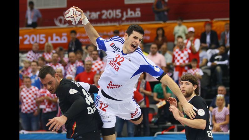 Croatia's Ivan Sliskovic scores a goal between two German players during a match at the Handball World Championship on Friday, January 30. Croatia won the match but finished sixth in the tournament, which was won by France in Qatar.