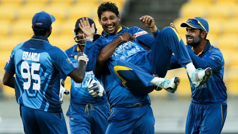 Tillakaratne Dilshan is congratulated by his Sri Lankan teammates after he took the wicket of New Zealand's Kane Williamson during a One Day International match played Thursday, January 29, in Wellington, New Zealand.