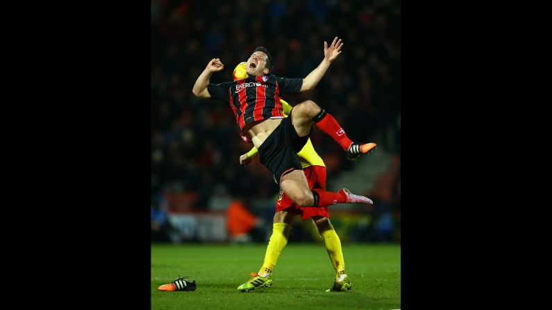 Bournemouth's Yann Kermorgant goes flying after clashing with Watford's Ben Watson during a soccer match played Friday, January 30, in Bournemouth, England. Bournemouth won 2-0 to stay atop the Championship, which is the second tier of English soccer.