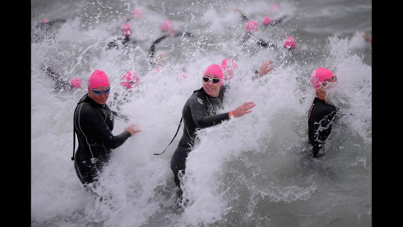 Competitors enter the water Sunday, February 1, during the swimming portion of the Challenge Melbourne triathlon.