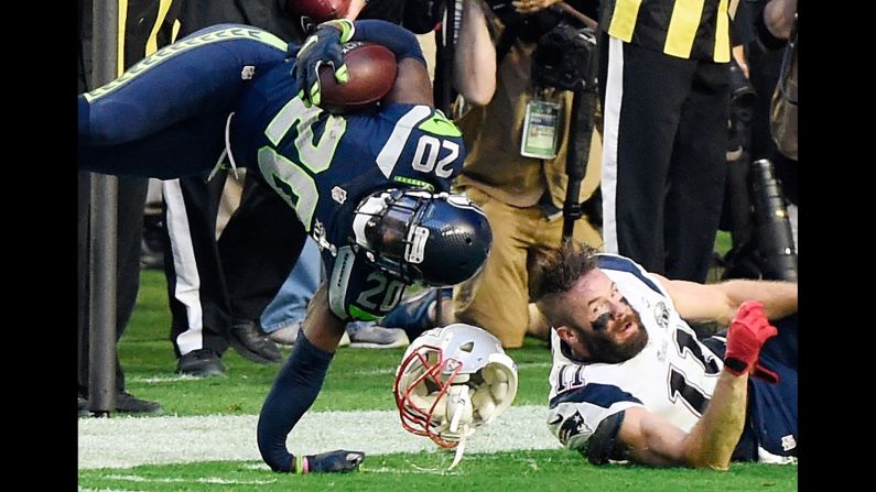 Seattle Seahawks defensive back Jeremy Lane suffers a broken arm after he was tackled by New England's Julian Edelman, right, during the first quarter of Super Bowl XLIX. Lane had just intercepted a pass from New England quarterback Tom Brady.