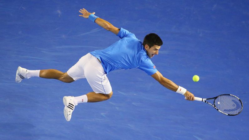 Novak Djokovic stretches for a backhand during a quarterfinal match at the Australian Open on Wednesday, January 28. Djokovic would eventually win the tournament, his fifth Australian Open title and his fourth in the past five years. Djokovic has now won eight Grand Slams.