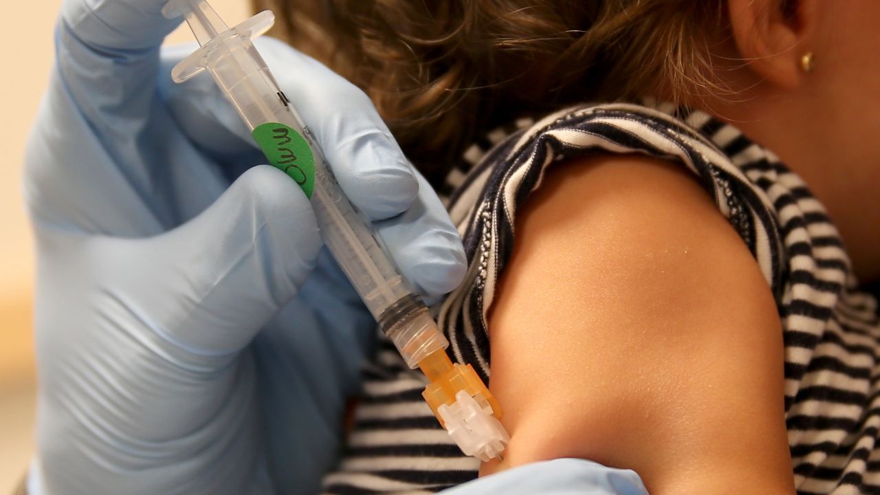 MIAMI, FL - JUNE 02:  Daniela Chavarriaga holds her daughter, Emma Chavarriaga, as pediatrician Jose Rosa-Olivares, M.D. administers a measles vaccination during a visit to the Miami Children's Hospital on June 02, 2014 in Miami, Florida. The Centers for Disease Control and Prevention last week announced that in the United States they are seeing the most measles cases in 20 years as they warned clinicians, parents and others to watch for and get vaccinated against the potentially deadly virus.  (Photo by Joe Raedle/Getty Images)