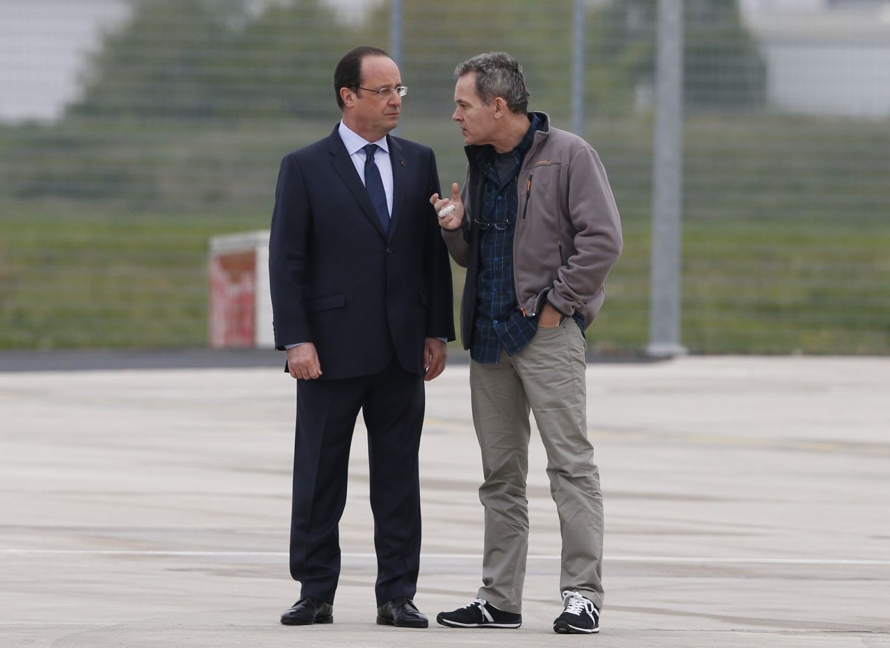 French Prime Minister Francois Hollande speaks with François at Villacoublay air base.