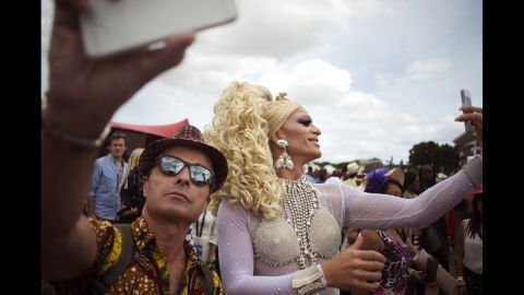 The rise in Africa's mobile market is staggering. Its population of mobile users now amount to 12% of all individual subscribers in the world and make up 6% of global revenue. This is a 70% increase when compared to figures published just five years ago. <br /><br />Pictured: Dressed up people take selfies at the running of the 38th J&B Met horse race on January 31, 2015, at the Kenilworth Race Course, in Cape Town. South Africa is amongst the top five countries for mobile usage in Africa. 