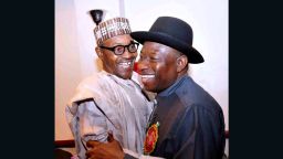 Nigerian President Goodluck Jonathan (R) and presidential candidate of the ruling People's Democratic Party (PDP) embraces leading opposition All Progressive Congress presidential candidate Mohammadu Buhari during a conference to promote non-violence.