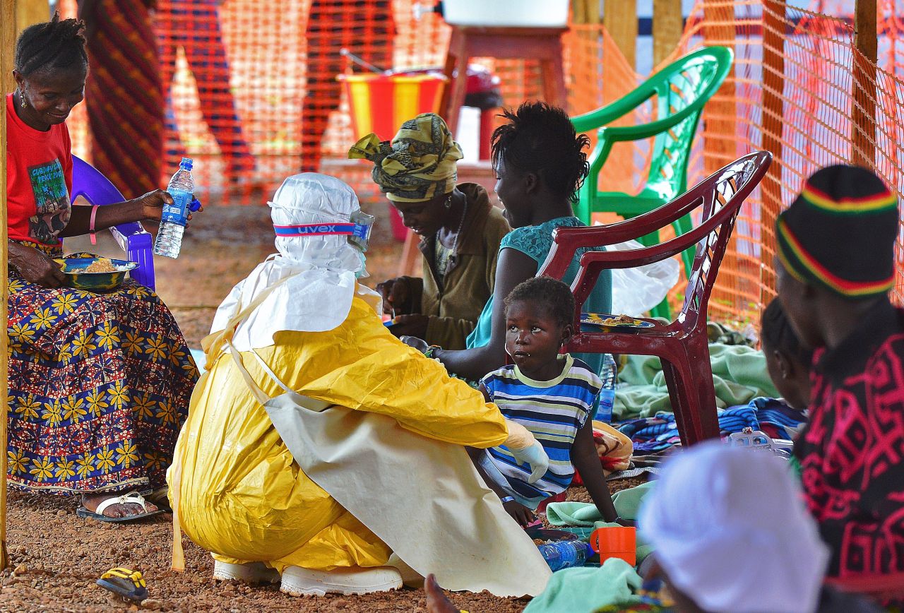 A medical worker feeds an Ebola victim at a Doctors Without Borders facility in Kailahun, Sierra Leone. There were hundreds of volunteers from all around the world who answered the call to help the people at the heart of the epidemic. 