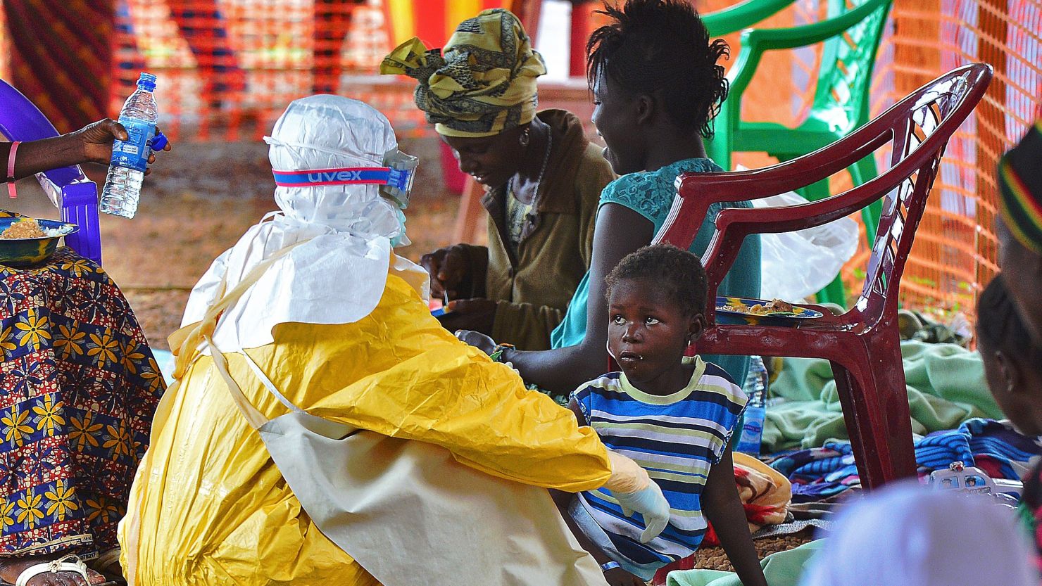 A MSF medical worker feeds an Ebola child victim at an MSF facility in Kailahun, Sierra Leone.