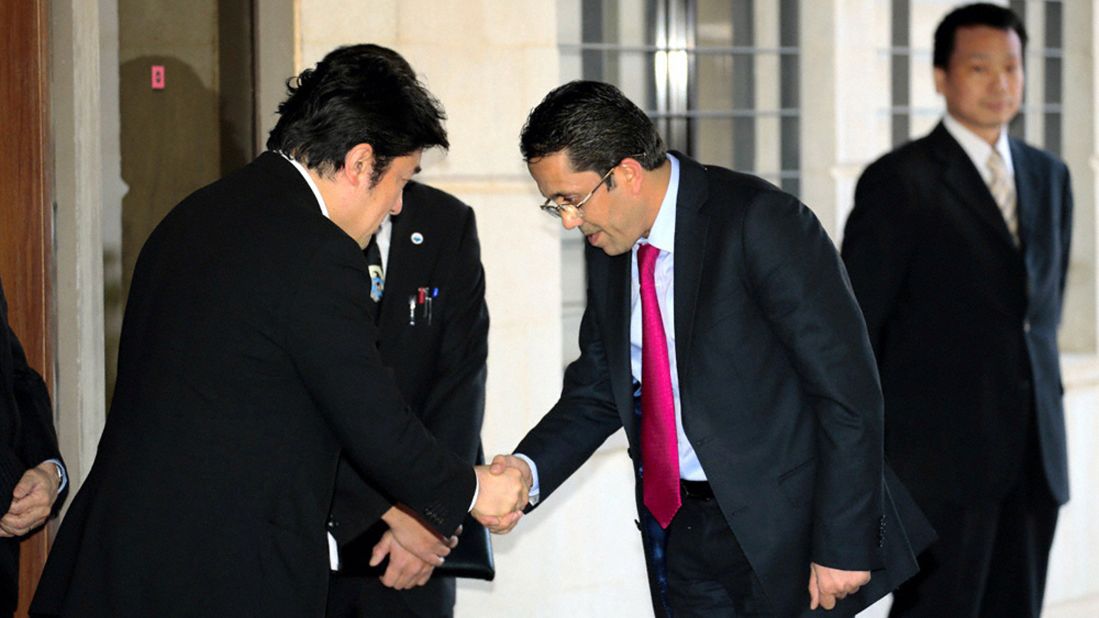 Japanese Vice Foreign Minister Yasuhide Nakayama, left, shakes hands with a Jordanian lawmaker visiting the Japanese Embassy in Amman on February 2. Two Japanese hostages, Haruna Yukawa and Kenji Goto, were also recently killed by ISIS.