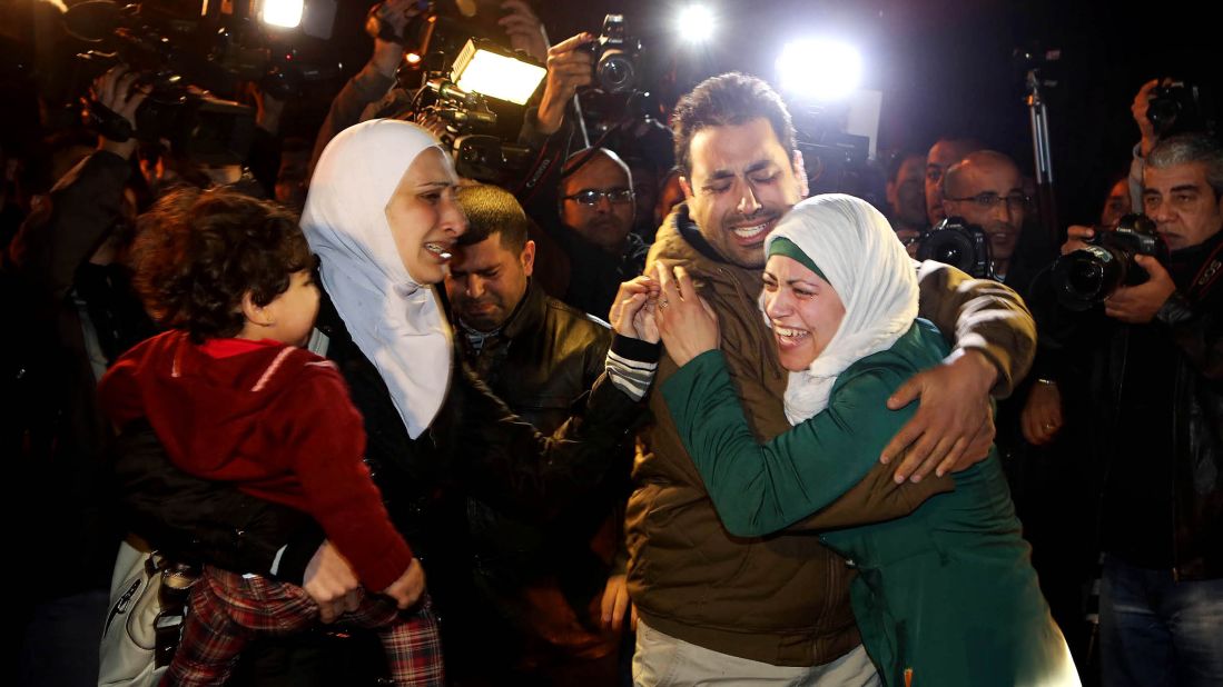 A man comforts al-Kasasbeh's wife during the protest in front of the royal palace on January 28.