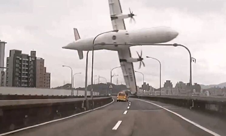 TransAsia Airways Flight GE235 clips a bridge in Taipei, Taiwan, shortly after takeoff Wednesday, February 4, in this still image taken from video. The ATR 72 twin-engine turboprop airplane then plunged into the Keelung River. More than 30 of the 58 passengers on board have been confirmed dead.