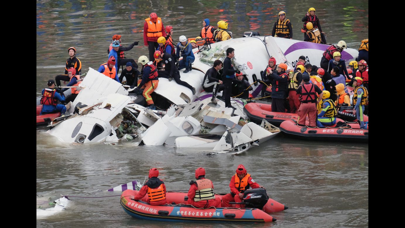 Rescue personnel search for passengers from the wreckage in the Keelung River in Taipei on February 4.