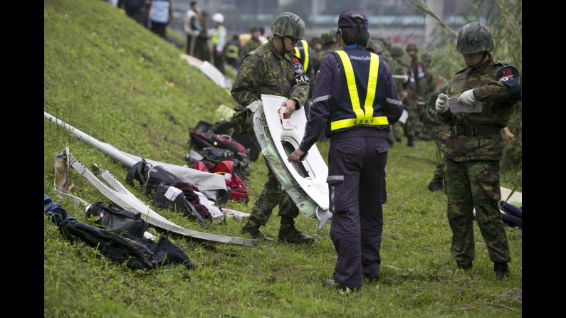 Debris from the plane crash is lined up along the riverbank on February 4.