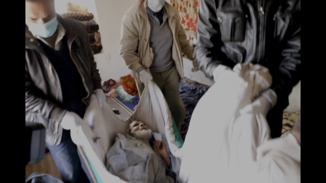 Ramue Dika, a civilian who died of starvation, is taken away from his house in Kobani on Monday, February 2.